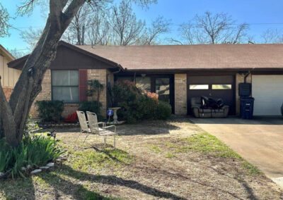 Exterior view of 6510 Oak Forest Ct Fort Worth Duplex with phrase Real Property Auction Auctioneer on Site Overlaid